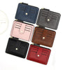 A collection of six compact leather card holder wallets in various shades including navy blue, gray, pink, brown, black, and 