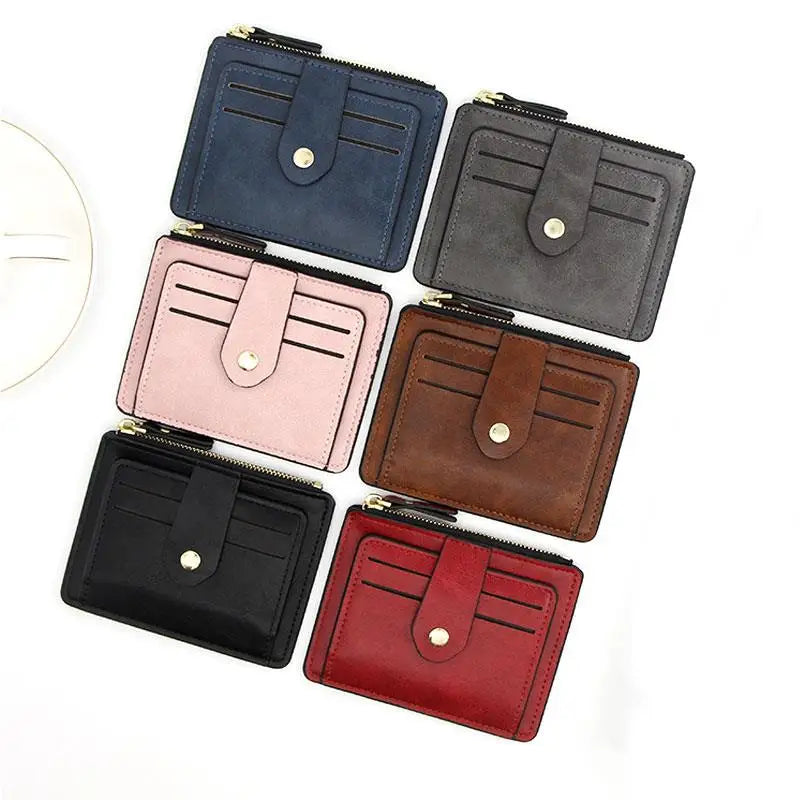 A collection of six compact leather card holder wallets in various shades including navy blue, gray, pink, brown, black, and 