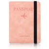A pink leather passport wallet with a stitched edge and a black strap.