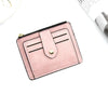 A pink leather card holder wallet with a flap and coin pocket shown on a white background.