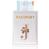 A pink leather passport holder with a gold embossed letter J and a passport visible behind it.