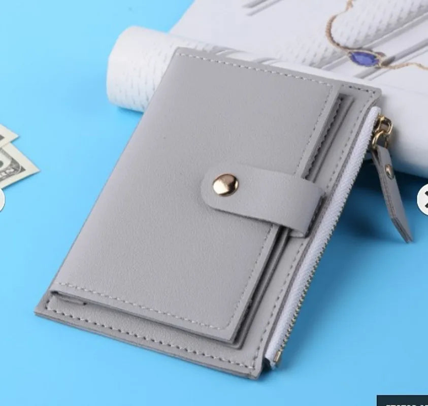 A light gray compact leather wallet with a zipper closure and a card holder is shown on a blue background.