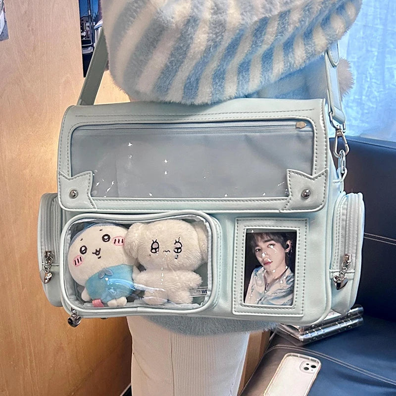 A light mint green transparent PU crossbody bag featuring two white stuffed bears and a portrait inside.