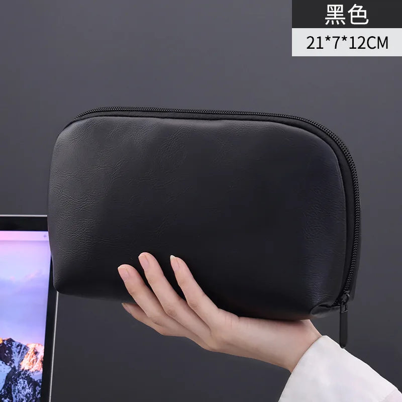Black leather multi-layer cable organizer pouch shown being held by a hand
