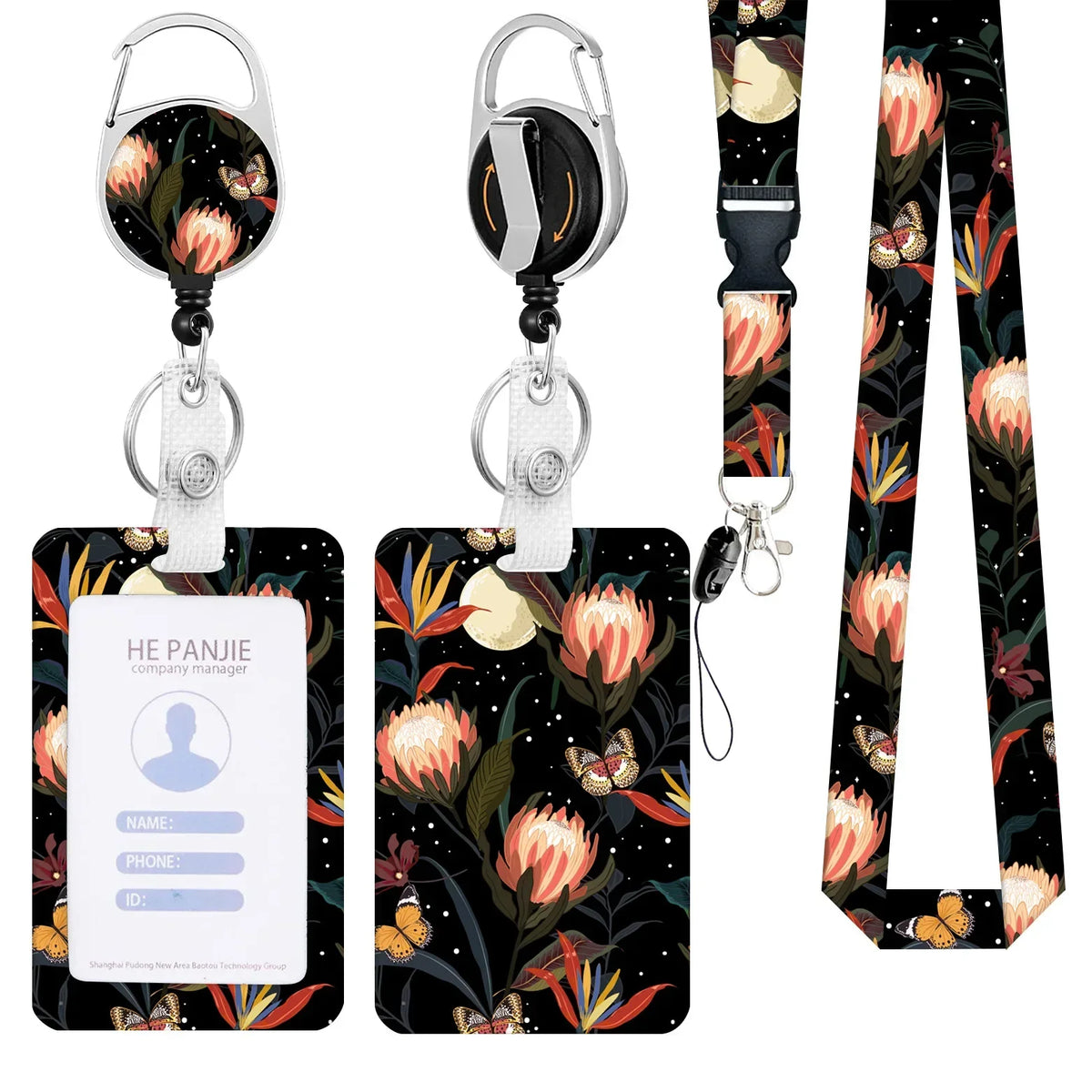 A black and floral patterned badge reel with a silver clip and a white strap lanyard.
