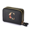 Black faux leather mini wallet with a gold zipper and a rose letter print