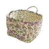 A quilted fabric storage basket with carry handles featuring a floral pattern.