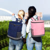 Two women wearing blue jeans and light shirts are carrying heavy duty leak-proof cooler backpacks outdoors.