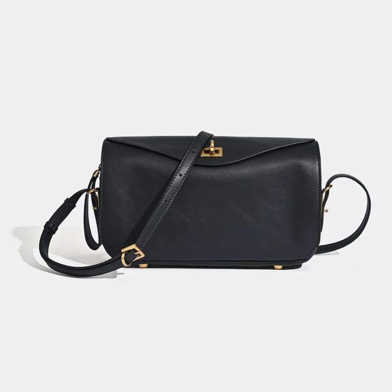 A black genuine leather square shoulder crossbody bag with gold hardware.