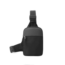 Black canvas crossbody sling bag with a strap shown from the back.
