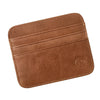A brown genuine leather slim card holder wallet with stitched edges and a circular embossed design.