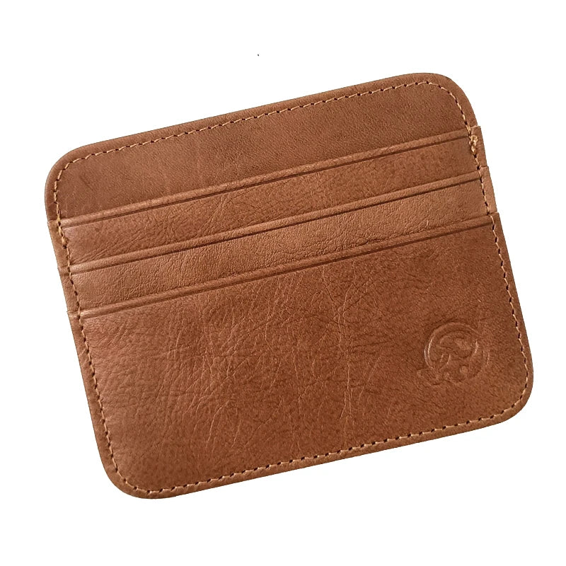 A brown genuine leather slim card holder wallet with stitched edges and a circular embossed design.