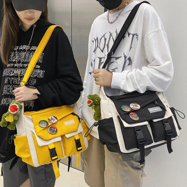 A woman is holding a yellow nylon crossbody shoulder bag with black accents and a white sweatshirt.