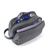 A gray toiletry bag with a zippered compartment and an attached strap, showing various cosmetic bottles inside.