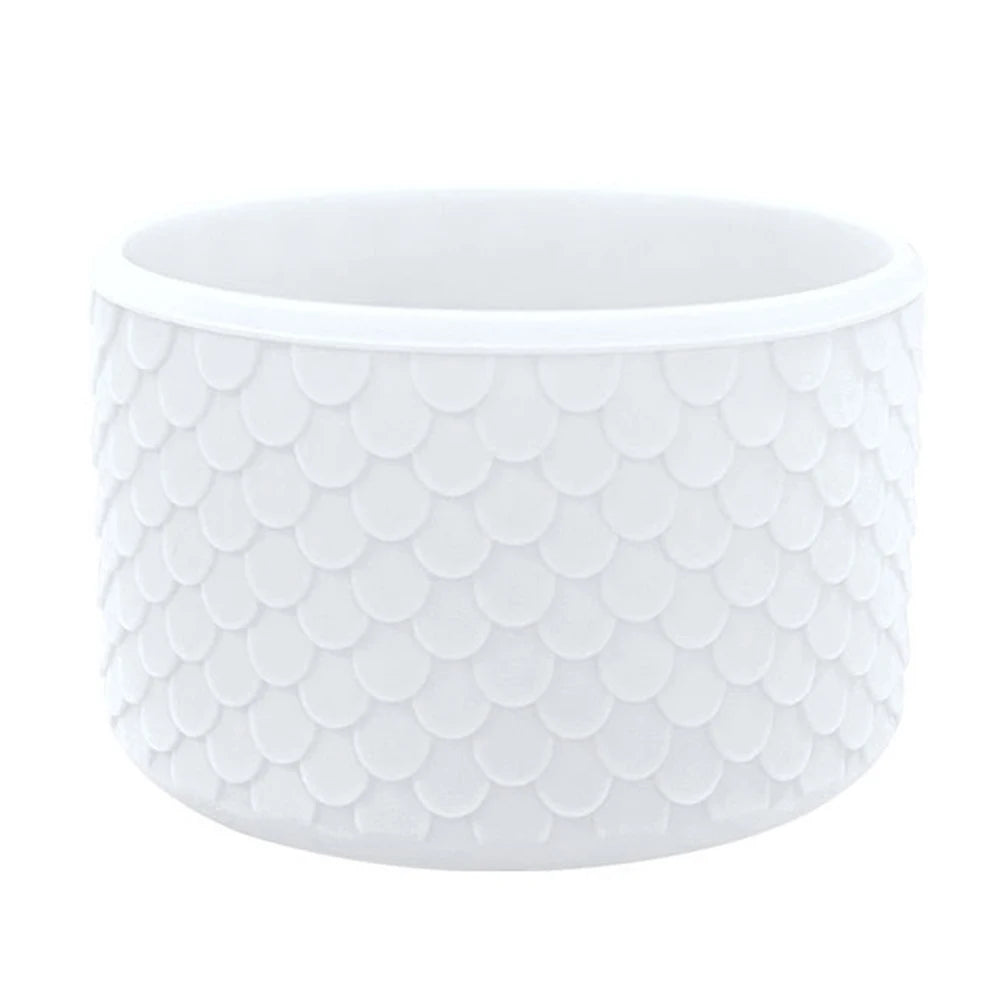White silicone boot sleeve for water bottles with a textured, scale-like pattern.