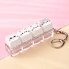 A clear plastic case holding several white kawaii cat keycaps and a silver keyring.
