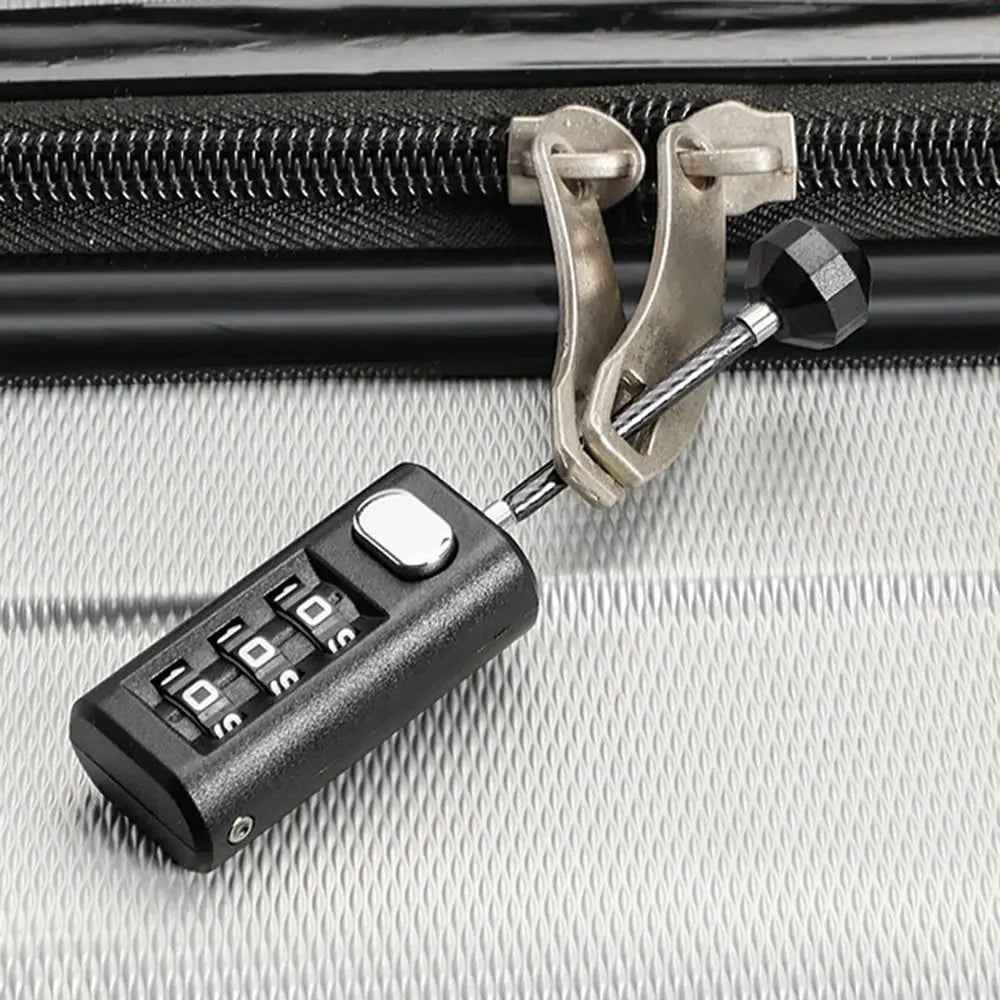 A black resettable 3-digit combination padlock with a brass clasp is shown against a gray textured surface.