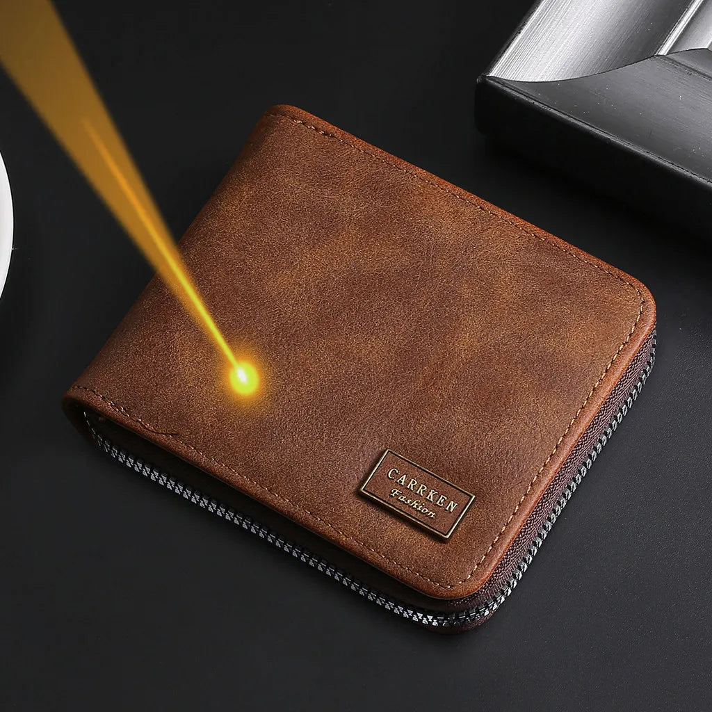 A brown leather zipper wallet with a gold engraving is shown on a dark surface.