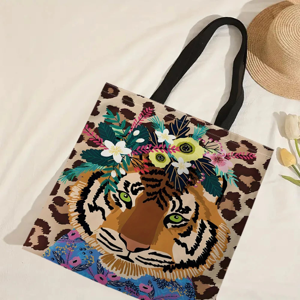 A canvas tote bag featuring an illustration of a tiger wreath in leopard print colors.
