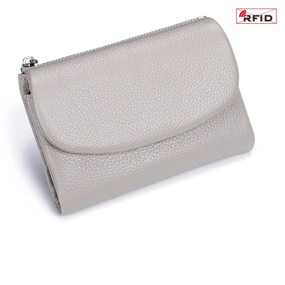 A light gray genuine leather mini card holder wallet with a zipper closure.