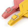 Two pink and yellow PU leather luggage tags with silver hardware shown diagonally.
