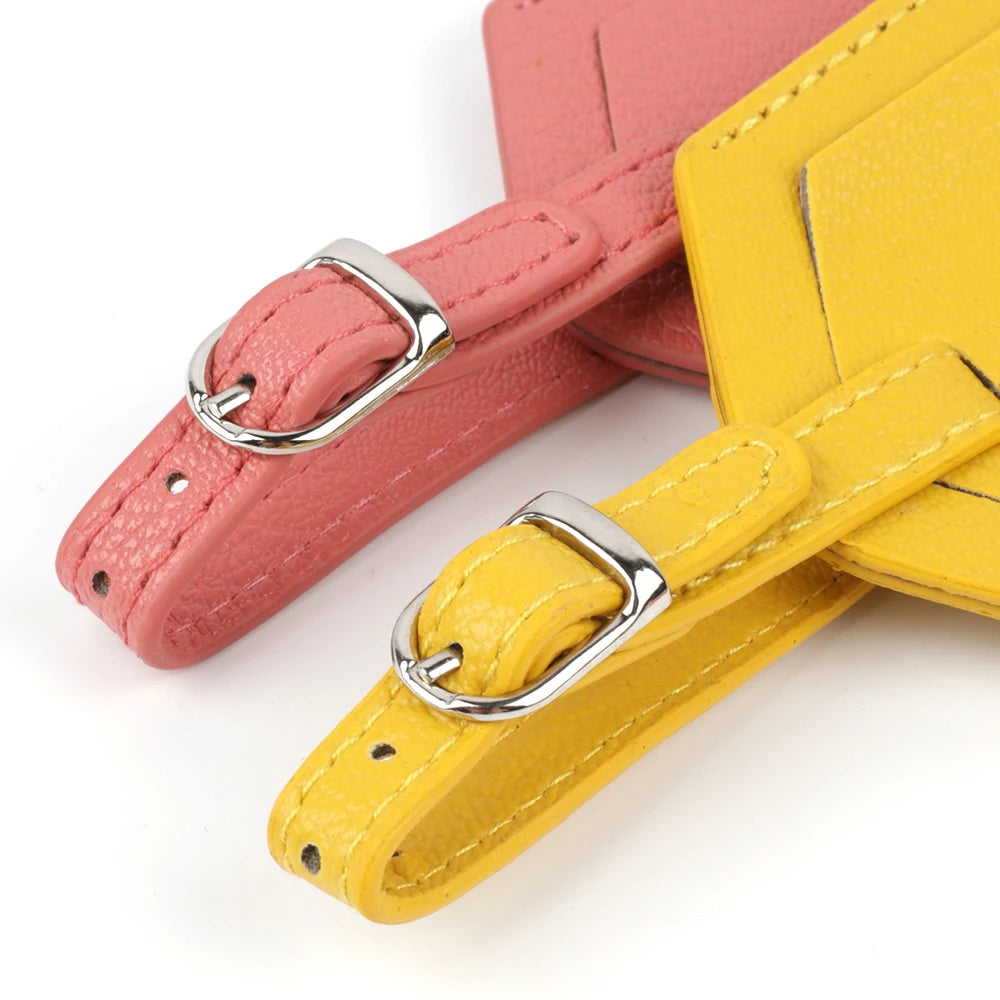Two pink and yellow PU leather luggage tags with silver hardware shown diagonally.