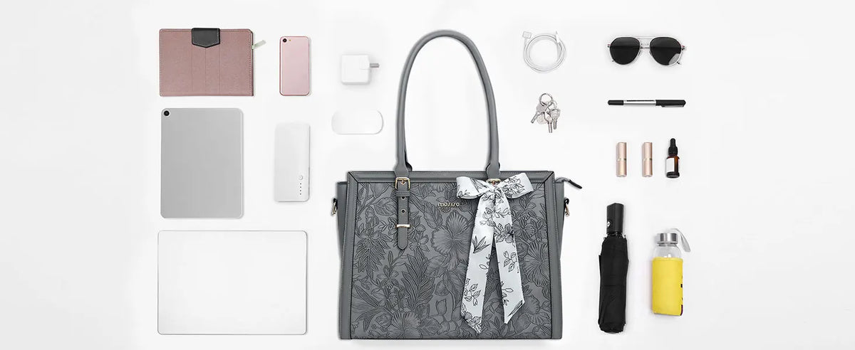 A gray vintage PU leather laptop tote bag with a patterned scarf and various accessories displayed on a white background.