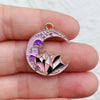 A silver-toned crescent moon charm featuring purple and pink gemstone designs for jewelry making.