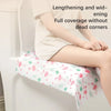 A person is using a disposable toilet seat cover with a floral pattern on a white toilet.