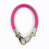A pink faux leather strap with metal buckles for a bag or item.
