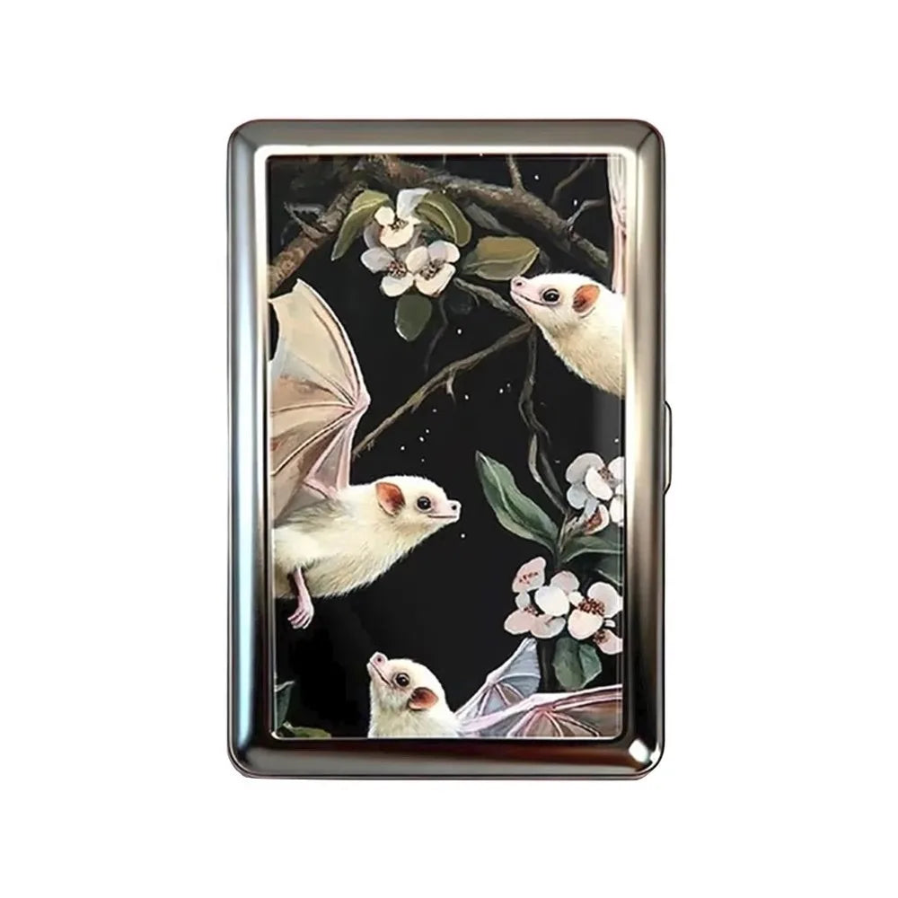 A vintage metal card holder featuring a detailed illustration of a white mouse and floral elements.