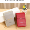 A display of two Endayon crossbody bags, one gray and one red, next to a small potted succulent plant.