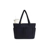 A navy blue quilted tote bag with a white cup inside, shown from the front.