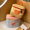 A yellow and pink cartoon insulated lunch bag with a checkered pattern and heart accents is displayed on a white surface.