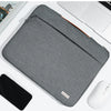 A gray multi-pocket laptop sleeve with a handle is shown next to a silver wireless mouse.