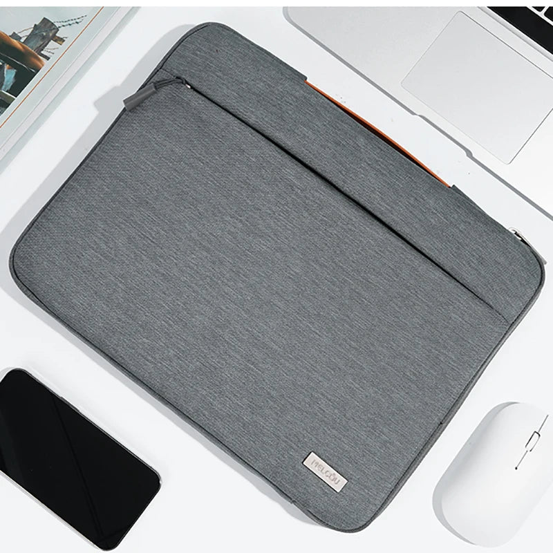 A gray multi-pocket laptop sleeve with a handle is shown next to a silver wireless mouse.