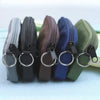 A row of five nylon mini coin purses in various colors, featuring double zippers and metal rings.