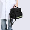 A person is holding a black durable waterproof emergency trauma bag.