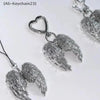 Silver metal angel wing keychain charm with a heart pendant