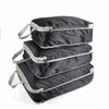 A stack of black reusable compression packing cubes.