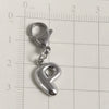 Silver stainless steel alphabet letter charm with a lobster clasp placed on a ruler.
