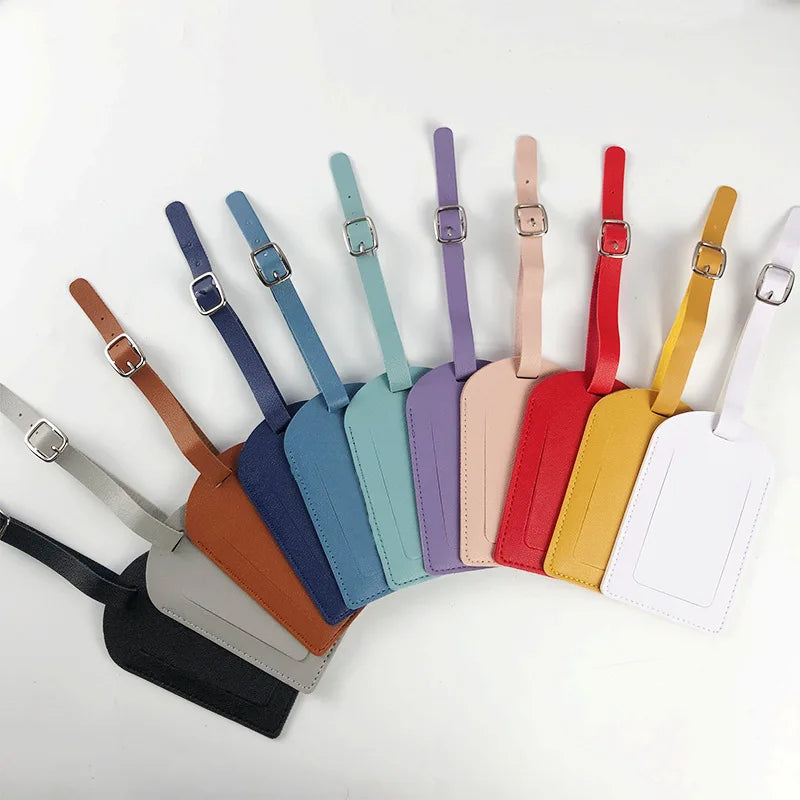 A collection of PU leather luggage tags in various colors including blue, green, purple, pink, red, yellow, and white.
