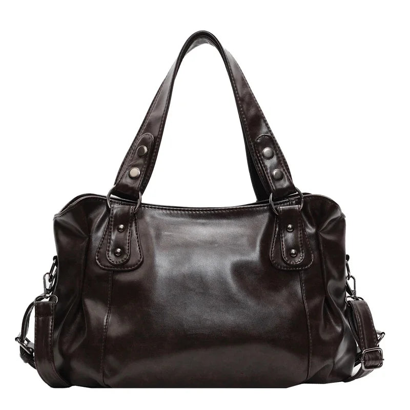 A dark brown vintage style leather tote bag with a crossbody strap.