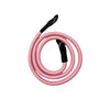 Pink adjustable camera and DSLR shoulder strap coiled on a white background
