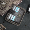 A dark brown genuine leather card wallet with multiple slots and a decorative embossed pattern is shown on a gray surface.
