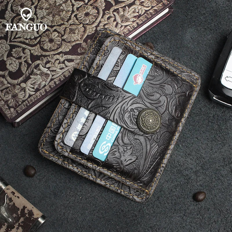 A dark brown genuine leather card wallet with multiple slots and a decorative embossed pattern is shown on a gray surface.