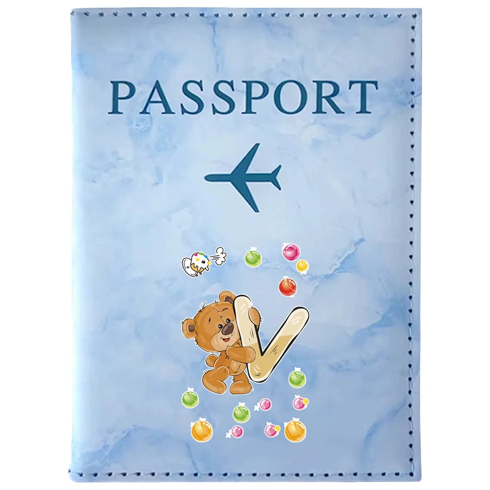 Light blue passport card holder featuring a vintage letter print design with a blue airplane and bear illustration