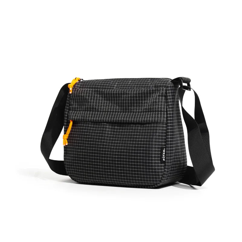 A black plaid water resistant crossbody shoulder bag with black straps.