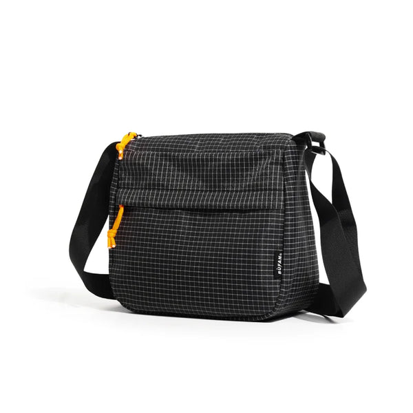 A black plaid water resistant crossbody shoulder bag with black straps.