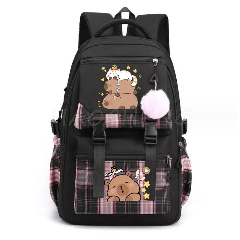 Black canvas backpack featuring a cute capybara print with a pink pom-pom charm